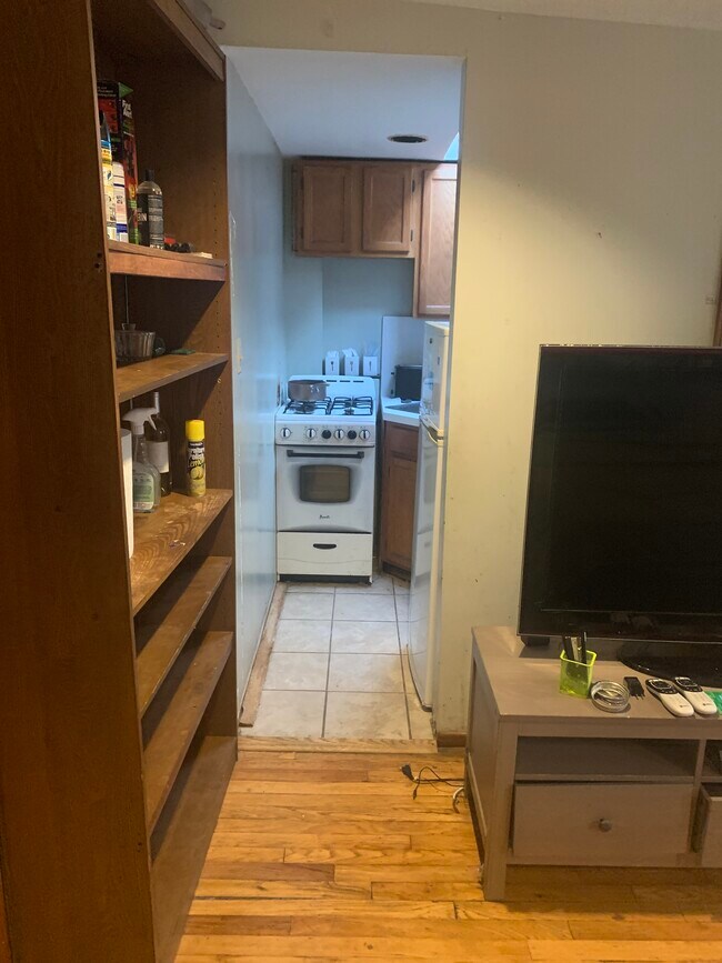 Small kitchen area with stove refrigerator and microwave - 75 Saint James Pl