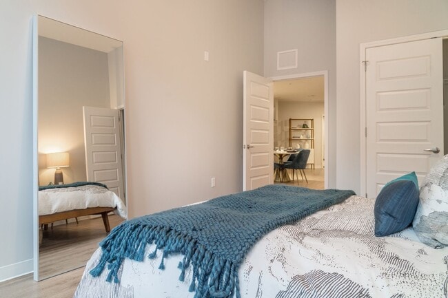 Bedroom with closet space and high ceiling - Liberty Lofts