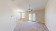 Located in Allison Park, PA, this well-designed single-floor, three-bedroom, two-bathroom home offers a comfortable and functional layout. The bright living room serves as the heart of the home, featuring soft carpeting, a ceiling fan, a pendant light fixture, and French doors that open onto a private balcony, allowing natural light to fill the space and providing pleasant outdoor views.

The kitchen is efficiently designed with light wood cabinetry, granite-look countertops, a full suite of white appliances including a range, built-in microwave, dishwasher, and refrigerator, and stone-tile flooring. A peninsula with a breakfast bar connects the kitchen seamlessly to the living area.

The spacious primary bedroom includes a ceiling fan, plush carpeting, and its own French door access. The two additional bedrooms are comfortably sized with soft carpet, natural light from windows with outdoor greenery views, and convenient closet access. Five closets throughout the home provide generous storage.

Both bathrooms feature stone-tile flooring, white vanities with mirrors, and clean, neutral finishes. One bathroom includes a shower stall. A dedicated utility room and a connecting hallway complete the thoughtful floor plan, making this home a practical and inviting residence.
