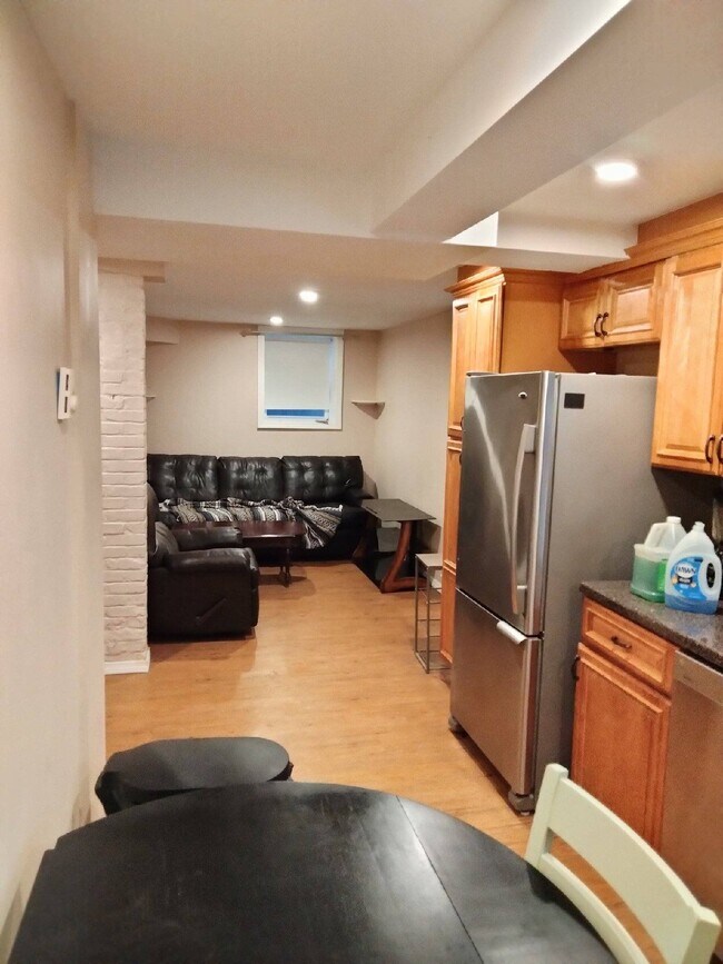 Living room with couch, leather chair, coffee table and TV stand - 4 Locke Rd