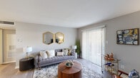Located at 1113 Hunters Glen Dr in Plainsboro, NJ, this 2-bedroom, 1-bathroom residence offers a well-designed single-floor layout with a cohesive, modern aesthetic. The combined kitchen and living room serves as the heart of the home, where the living area features hardwood-style flooring, neutral gray walls, and a large sliding glass door fitted with vertical blinds that fills the space with natural light and provides direct access to an outdoor patio with greenery views. The kitchen is outfitted with white cabinetry, gray countertops, a stainless steel refrigerator, and matching appliances, all set above light wood-tone flooring that enhances the clean, contemporary feel. The primary bedroom offers plush carpeting, a bright window with outdoor views, and ample space for a full furniture arrangement. The second bedroom also features hardwood-style flooring and an open closet with built-in shelving. The full bathroom is finished with white cabinetry, a white countertop, light wood-tone flooring, and a shower-tub combination with a curved curtain rod. Throughout the residence, soft neutral tones, consistent finishes, and thoughtful layouts create a comfortable and practical living environment.