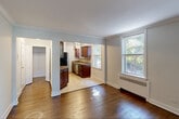 Located at 188 Bellevue Avenue in Montclair, NJ, this well-appointed one-bedroom, one-bathroom unit offers a thoughtfully organized layout across a single floor. The entry hallway, accented with elegant crown molding and gleaming dark hardwood floors, sets an inviting tone and leads seamlessly into the main living areas.

The living room is a bright, open space featuring two large double-hung windows that frame lush, tree-lined views and flood the room with natural light. Crown molding and rich hardwood flooring continue throughout, lending a cohesive, classic character to the space.

The bedroom is a comfortable retreat with a dedicated closet, hardwood floors, and a window overlooking greenery, providing a peaceful, private atmosphere. The room also features a wall-mounted HVAC unit for personalized climate control.

The kitchen is efficiently designed with warm, rich wood cabinetry, granite-style countertops, a tile backsplash, a stainless steel sink, and light tile flooring. A window above the counter brings in natural light and garden views, making the space feel open and functional.

The bathroom features full floor-to-ceiling neutral tile work surrounding a bathtub-shower combination enclosed by a glass sliding door, complemented by a frosted window for natural light and privacy. The overall ambiance of this unit is clean, classic, and well-maintained.