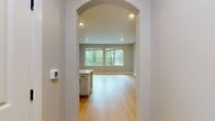 This contemporary 820 square foot apartment in Towson, MD, showcases a thoughtful layout maximizing space and functionality. The single-level unit boasts an open floor plan, seamlessly connecting the living areas. Light oak hardwood floors run throughout, complementing the neutral wall tones and creating a bright, airy atmosphere.

The spacious bedroom, measuring 160 square feet, features large windows offering verdant views and ample natural light. A sizable closet with bifold doors provides generous storage. The modern bathroom is outfitted with a white subway-tiled shower/tub combination, a sleek vanity, and a large mirror.

The kitchen is a highlight, featuring crisp white cabinetry, stainless steel appliances, and a subway tile backsplash. It opens to the living area, ideal for entertaining. The living room is bathed in natural light from expansive windows, showcasing treetop views.

Industrial-style exposed ductwork adds character to the space, while recessed lighting and pendant fixtures provide layered illumination. The apartment's two entrances and hallway enhance circulation. With its blend of modern amenities and thoughtful design, this apartment offers a comfortable, stylish living experience in a prime Towson location.