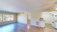 Located at 2021 Peyton Ave in Burbank, CA, this one-bedroom, two-bathroom residence offers a well-organized single-floor layout designed for comfortable everyday living. The open living room is finished with light hardwood-style flooring and neutral warm-toned walls, creating a bright and welcoming atmosphere. A large window floods the space with natural light and frames views of surrounding greenery, adding a sense of openness to the room. The bedroom is a generously sized retreat, equipped with a ceiling fan with light fixture, a double-door closet, and a window with outdoor views, continuing the hardwood-style flooring found throughout. The kitchen features white cabinetry, a coil electric range, a built-in microwave, a sink, and tile flooring beneath a recessed ceiling with overhead lighting, offering a clean and functional cooking space. Two bathrooms serve the unit — one featuring a tiled shower/tub combo with sliding glass doors and chrome fixtures, and the other a full bathroom with a white vanity, stone-topped countertop, a mirrored medicine cabinet, and tile flooring. Throughout the unit, consistent finishes and neutral tones create a cohesive and practical living environment in this Burbank location.