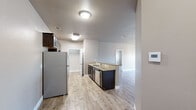 Located at 704 Dale Ln in White Settlement, TX, this single-story 2-bedroom, 2-bathroom home offers a functional and modern living experience. Light wood-look flooring flows throughout the main living areas, complementing the neutral-toned walls and creating a bright, cohesive atmosphere.

The kitchen is a standout feature, equipped with dark espresso cabinetry, granite countertops, a stainless steel refrigerator, built-in microwave, and additional appliances. A peninsula with a sink adds prep space and connects the kitchen to the open living area, enhancing the overall flow of the home.

Both bedrooms are carpeted and receive natural light through blinded windows. The spacious primary bedroom includes a ceiling fan, while the secondary bedroom offers a similarly comfortable feel. Each room benefits from dedicated closet space.

The two bathrooms are clean and modern, each featuring dark vanity cabinetry, white countertops, large mirrors, and chrome fixtures. One bathroom includes a full tub-shower combo. A dedicated laundry area with an included washer adds everyday convenience.

The home's single-floor layout ensures easy accessibility throughout, making it a practical and inviting residence in the White Settlement community.