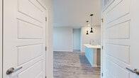 Located in Covington, Kentucky, this single-floor residence offers a thoughtfully designed layout with modern finishes throughout. The open-concept kitchen serves as a central highlight, featuring light wood cabinetry, quartz countertops, a subway tile backsplash, stainless steel appliances including a range, built-in microwave, and refrigerator, along with a center island with pendant lighting — ideal for both cooking and casual dining. Durable wood-look flooring flows through the main living and kitchen areas, complementing the clean, neutral color palette.

The living room is spacious and bright, benefiting from multiple windows that invite natural light, and is equipped with a ceiling fan for year-round comfort. Direct access to an outdoor area is also available from this space. The bedrooms are finished with plush carpeting and feature windows that frame scenic views of the surrounding Covington skyline.

The two bathrooms are finished to a high standard: one includes a glass-enclosed walk-in shower with large-format tile, while the second offers a tiled tub-surround combination with a window for natural light. Both bathrooms feature wood-look flooring and modern vanities with white countertops. The overall ambiance is clean, contemporary, and move-in ready.
