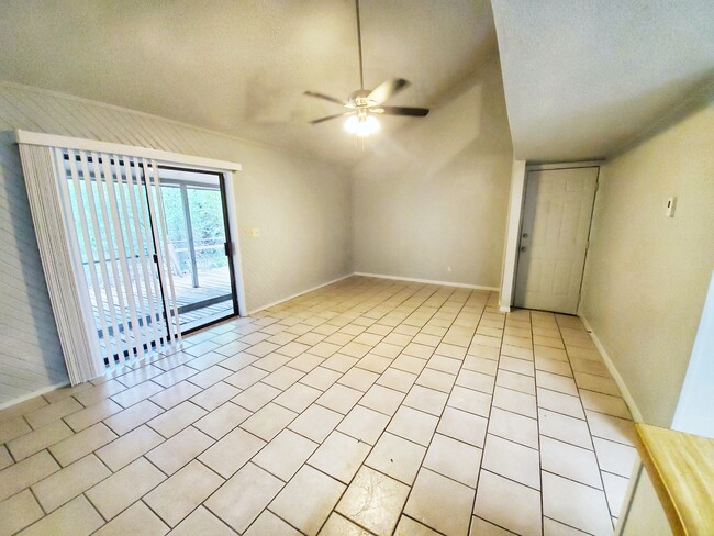 Tiled living room with vaulted ceiling and new ceiling fan. - 28600 Netawake Ct