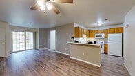 Located at 223 S Pleasant View Rd in Plymouth, WI, this single-floor, one-bedroom, one-bathroom residence offers a well-organized and functional layout. The open-concept living, dining, and kitchen area forms the heart of the home, finished with light-toned luxury vinyl plank flooring and neutral wall colors throughout. A ceiling fan anchors the living space, which flows naturally toward a sliding door leading to a private patio with outdoor views of mature greenery. The kitchen is well-appointed with warm oak cabinetry, ample counter space, a double-basin sink, and white appliances including a range, over-the-range microwave, and refrigerator. A peninsula counter serves as a natural divide between the kitchen and dining area. The bedroom is a comfortable, carpeted retreat featuring a window with natural light, two closets for generous storage, and a thermostat for individual climate control. The full bathroom includes a wood-toned vanity, LVP flooring, and a shower/tub combination. A dedicated laundry room with upper cabinetry, washer/dryer hookups, and an in-unit water heater adds everyday convenience. This residence combines practicality and comfort in a clean, move-in-ready package.
