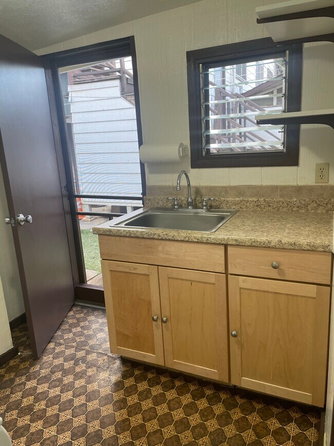 Newer kitchen cabinets, counter - 1927 Kalani St