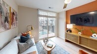Located in the heart of uptown Charlotte at 426 N Tryon St, this one-bedroom, one-bathroom residence offers a well-designed layout across a single floor. Light-toned hardwood flooring runs throughout, creating a cohesive and airy feel.

The kitchen is a standout, featuring two-tone cabinetry with teal lower cabinets and crisp white uppers, a white subway tile backsplash, stainless steel appliances including a French door refrigerator, electric range, and built-in microwave, plus a breakfast island ideal for casual dining. The open layout connects seamlessly to the combined dining and living area, which is anchored by a bold terracotta accent wall and large sliding glass doors that lead to a private balcony with pool views.

The bedroom is a comfortable retreat with a ceiling fan, natural light from a window overlooking the city, and easy access to the closet. The bathroom features a full soaking tub with white subway tile surround and clean, neutral finishes. A dedicated office space adds valuable flexibility, while the in-unit laundry area includes a stacked washer and dryer with built-in shelving for added storage convenience.