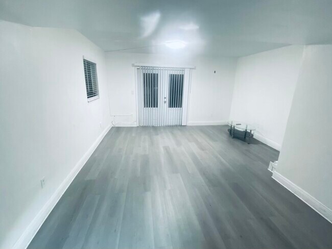 Living room area with beautiful double doors that open to personal balcony - 10901 N Kendall Dr