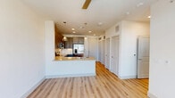 Located at 4245 Bobtown Rd in Garland, TX, this thoughtfully designed one-bedroom, one-bathroom unit offers a functional and modern living experience across a single floor. The open-concept layout seamlessly connects the dining room, kitchen, and living room, creating an inviting and efficient use of space. Light-toned hardwood-style flooring flows throughout the main living areas, enhancing the bright, airy ambiance.

The kitchen is a standout feature, outfitted with gray shaker-style cabinetry, a white subway tile backsplash, quartz countertops, and a full suite of stainless steel appliances including a refrigerator, electric range, microwave, and dishwasher. A peninsula with a stainless steel farmhouse sink and pendant lighting above serves as both a prep area and casual dining space. A balcony extends the living area outdoors, accessible from the main living space.

The bedroom is carpeted and filled with natural light from multiple windows. It is complemented by three closets, offering generous storage throughout. The bathroom features a glass-enclosed walk-in shower with white subway tile, wood-style flooring, and direct access to a walk-in closet. Additional practical spaces include a dedicated laundry area, utility room, pantry, and hallway, ensuring everyday convenience is built right in.