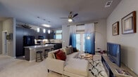 Located at 3100 Merritt Rd in Rowlett, TX, this single-floor residence offers a thoughtfully designed open-concept layout that seamlessly connects the living, dining, and kitchen areas. The living room features plush carpeting, a ceiling fan, and a glass-paned door that invites natural light and leads to an outdoor space, creating an airy and welcoming atmosphere.

The gourmet kitchen is a standout feature, boasting rich dark cabinetry that extends to the upper walls, a mosaic tile backsplash, granite countertops, a large kitchen island with bar seating, wood-look flooring, and a full suite of black appliances. Pendant lighting adds a refined finishing touch overhead.

The bedrooms are generously proportioned, each offering plush carpeting, ceiling fans, and multiple windows that allow ample natural light. The primary bedroom includes direct access to a spacious walk-in closet and an en-suite bathroom. The primary bathroom is elegantly appointed with a dual-sink vanity featuring granite countertops, dark cabinetry, wood-look flooring, and a separate glass-enclosed shower. A secondary bathroom offers a tiled tub-shower combination with granite countertops, providing equal attention to detail throughout the home.