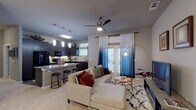 Located at 3100 Merritt Rd in Rowlett, TX, this single-floor residence offers a thoughtfully designed open-concept layout that seamlessly connects the living, dining, and kitchen areas. The living room features plush carpeting, a ceiling fan, and a glass-paned door that invites natural light and leads to an outdoor space, creating an airy and welcoming atmosphere.

The gourmet kitchen is a standout feature, boasting rich dark cabinetry that extends to the upper walls, a mosaic tile backsplash, granite countertops, a large kitchen island with bar seating, wood-look flooring, and a full suite of black appliances. Pendant lighting adds a refined finishing touch overhead.

The bedrooms are generously proportioned, each offering plush carpeting, ceiling fans, and multiple windows that allow ample natural light. The primary bedroom includes direct access to a spacious walk-in closet and an en-suite bathroom. The primary bathroom is elegantly appointed with a dual-sink vanity featuring granite countertops, dark cabinetry, wood-look flooring, and a separate glass-enclosed shower. A secondary bathroom offers a tiled tub-shower combination with granite countertops, providing equal attention to detail throughout the home.