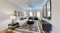 Located at 3300 Murfreesboro Pike in Nashville, TN, this multi-story townhome offers a well-organized layout spread across three floors. The ground level houses an attached garage with an automatic opener, concrete flooring, and direct interior access — providing both convenience and secure storage. The main living floor features an open-concept kitchen and living room combination. The kitchen is outfitted with white shaker cabinetry, granite countertops, tile backsplash, and wood-look flooring, while the living area impresses with crown molding, a ceiling fan, and generous natural light from multiple windows. A half bathroom on this level adds everyday practicality. The upper floor accommodates two carpeted bedrooms, each with ceiling fans, closets, and windows dressed with curtains. The spacious primary bedroom offers a calm, neutral palette. A dedicated office provides a quiet workspace, complete with crown molding and ample room for furnishings. The three bathrooms are finished with granite vanities, white cabinetry, and tile flooring; one full bath includes a tiled tub-shower surround. Two staircases and hallways connect the floors efficiently, making this a functional and comfortable Nashville home.
