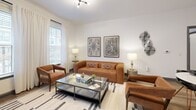 This contemporary 950 square foot apartment in Richmond, VA offers a harmonious blend of style and functionality. The open-concept layout maximizes the use of space, creating a seamless flow between the living areas. The kitchen is a standout feature, boasting gray cabinetry, stainless steel appliances, and a spacious island with seating, perfect for casual dining or entertaining.

The two bedrooms are well-appointed, with the primary bedroom spanning 160 square feet. Both rooms feature large windows that allow natural light to flood in, enhancing the airy feel of the space. The bathrooms are modern and sleek, with one showcasing a double vanity and ample storage.

The living room is tastefully decorated with comfortable seating and modern art pieces, creating an inviting atmosphere. Throughout the apartment, hardwood-style flooring adds warmth and elegance. The in-unit laundry room, equipped with full-sized appliances, offers convenience and practicality.

Attention to detail is evident in the carefully chosen light fixtures, window treatments, and decorative elements that contribute to the overall contemporary aesthetic. This well-designed apartment combines comfort and style, making it an ideal urban dwelling in the heart of Richmond.