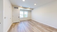 Located at 301 Station Dr in Dublin, PA, this 1-bedroom, 1-bathroom residence offers a thoughtfully designed single-level layout with modern finishes throughout. The open-concept kitchen and living area serves as the heart of the home, showcasing granite countertops, crisp white shaker cabinetry, stainless steel appliances including a refrigerator with ice maker, electric range, microwave, and dishwasher, all illuminated by stylish pendant lighting. Light wood-tone flooring runs throughout the main living areas, lending a clean and contemporary feel. The living area is bright and open, with windows that invite natural light and outdoor views. The bedroom is a comfortable retreat featuring plush carpeting, dual windows with outdoor views, and ample space for furnishings. A dedicated closet provides convenient storage. The full bathroom is finished in neutral tones with a tub/shower combo, a vanity with a marble-style countertop, and recessed lighting. A dedicated laundry area houses a stacked full-size washer and dryer for added convenience. The overall ambiance is fresh, modern, and move-in ready, offering a practical yet refined living experience.