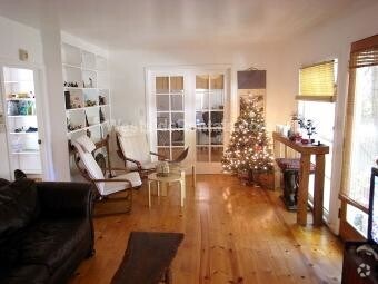Living room with French doors to bedroom 1 - 3626 Veteran Ave