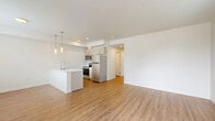 Located at 16525 Ash Way in Lynnwood, Washington, this well-appointed one-bedroom, one-bathroom unit offers a thoughtfully designed single-floor layout finished with contemporary details throughout. Warm wood-look flooring flows continuously across every room, creating a cohesive and inviting atmosphere.

The combined kitchen and living area serves as the heart of the unit. The kitchen is equipped with a full suite of stainless steel appliances, including a refrigerator, range, microwave, and dishwasher. Light wood cabinetry pairs cleanly with a crisp white quartz peninsula countertop, which also functions as a breakfast bar. Stylish pendant lighting hangs above the peninsula, adding a modern touch. Recessed lighting and natural light from nearby windows keep the space bright and open.

The bedroom is a comfortable, well-proportioned room featuring a large window that brings in natural light and exterior views, a wall-mounted mini-split unit for climate control, and a double-door closet providing ample storage. A private exterior door also opens from the living area.

The bathroom continues the clean, modern aesthetic with light wood vanity cabinetry, white quartz countertops, and a bathtub. A connecting hallway links the bedroom and bathroom efficiently.

The overall design is clean, bright, and modern, making this a functional and attractive space in the Lynnwood area.