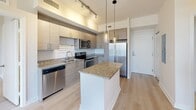 Located at 817 SE Second Ave in Fort Lauderdale, FL, this modern 3-bedroom, 2-bathroom residence offers a thoughtfully designed open-concept layout with contemporary finishes throughout. The kitchen serves as the heart of the home, showcasing granite countertop surfaces, a central island with pendant lighting, sleek taupe cabinetry, and a full suite of stainless steel appliances including a refrigerator, range, microwave, and dishwasher. Track lighting overhead enhances both functionality and ambiance. The kitchen flows seamlessly into the living area, which features light wood-style flooring, a ceiling fan, and access to a private balcony that invites natural light and outdoor views of the Fort Lauderdale cityscape. Each of the three bedrooms is appointed with the same light flooring, ceiling fans, and large windows that frame views of the surrounding neighborhood. The two bathrooms are finished with neutral tile flooring, tiled tub-shower combinations, granite-topped vanities, and wood-toned cabinetry, maintaining a cohesive modern aesthetic. Two closets provide practical storage solutions. The overall design palette of whites, warm neutrals, and light wood tones creates a bright, clean, and inviting atmosphere throughout the residence.