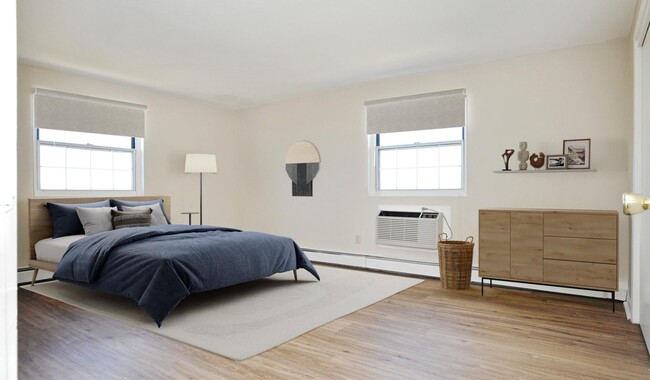 Bedroom with wood flooring and a large closet - Waterford Village Apartments