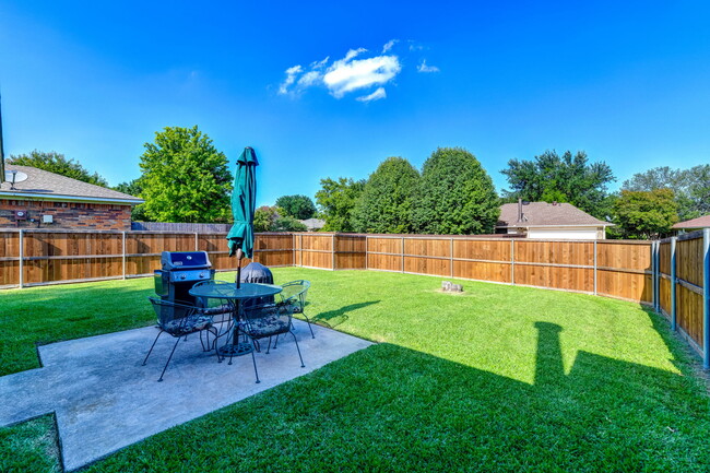 Large fenced backyard (great for dogs). Patio with table and chairs and Weber gas grill - 7312 Augusta Cir