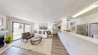 Located at 1770 N Green Valley Pkwy in Henderson, Las Vegas, this one-bedroom, one-bathroom unit offers a well-designed, single-level layout with a bright, neutral palette throughout. The open-concept living room is a welcoming centerpiece, featuring crown molding, wood-look flooring, a cozy fireplace, and a sliding glass door that opens to a private patio with outdoor views. The adjacent dining area benefits from natural light streaming through large windows and includes a ceiling fan overhead, creating a comfortable space for everyday meals. The galley-style kitchen is efficiently designed with white shaker cabinetry, light quartz countertops, a peninsula breakfast bar, and a full suite of stainless steel appliances including a gas range, microwave, dishwasher, and refrigerator. A louvered door off the kitchen leads to a dedicated laundry area. The bedroom is a serene retreat with wood-look flooring, natural light from a window with outdoor views, and a dedicated closet for storage. The bathroom features a full tiled tub-shower combination, a vanity with white cabinetry, and clean, bright finishes throughout. A hallway connects the rooms seamlessly, completing this efficiently laid-out and move-in-ready home.