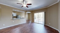 Located at 8506 29th Way N in Pinellas Park, Florida, this two-bedroom, two-bathroom two-story home offers a well-organized layout across its two levels. The main living area is bright and open, featuring rich hardwood-style flooring, crown molding, and ceiling fans throughout. A sliding glass door leads to a private patio, filling the living and dining spaces with natural light and offering peaceful outdoor views of surrounding trees.

The galley-style kitchen is thoughtfully designed with white cabinetry, granite-style countertops, tile flooring, stainless steel appliances including a refrigerator and dishwasher, a built-in sink, and track lighting overhead. A pass-through connects the kitchen to the living and dining areas, enhancing the open feel.

Both bedrooms are carpeted and include ceiling fans, with the primary bedroom offering a comfortable, generously sized retreat. The two bathrooms feature hardwood-style flooring and clean white fixtures, including a tub-shower combination. An in-unit laundry room houses a full-size Whirlpool washer and dryer. The attached garage provides convenient parking and additional storage. With four closets and multiple hallways, this home offers ample storage throughout.