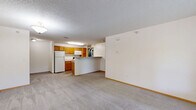 Located at 1170 Northwood Dr in Eagan, Minnesota, this 1-bedroom, 1-bathroom unit offers a functional and comfortable single-floor layout. The open-concept living room and kitchen area create a welcoming, spacious feel, with plush wall-to-wall carpeting, neutral walls, and textured ceilings throughout. A large window in the living room frames views of lush greenery outside, filling the space with natural light, while a front entry door provides convenient access.

The kitchen is well-appointed with warm oak cabinetry, ample counter space, a breakfast bar peninsula, and tile flooring. White appliances — including a refrigerator, electric range, and built-in microwave — are all included. The kitchen flows directly into a utility room equipped with a full-size washer and dryer, adding exceptional convenience.

The bedroom is a comfortable, carpeted retreat with its own window overlooking the surrounding greenery, offering a quiet and private atmosphere. The bathroom features tile flooring, an oak vanity, and a full soaking tub with shower. Throughout the unit, warm oak-toned doors and trim provide a cohesive, classic aesthetic, making this a practical and inviting Eagan residence.