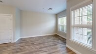 This 720 square foot apartment in Hamden, CT, showcases a thoughtful design that maximizes space and comfort. The open-concept layout seamlessly integrates the living area and kitchen, creating a spacious feel. Large windows throughout flood the space with natural light and offer pleasant views. The kitchen boasts dark wood cabinetry, granite countertops, and stainless steel appliances, anchored by a central island. The bedroom, measuring 140 square feet, provides ample space and features the same warm wood flooring found throughout. The bathroom is equipped with modern fixtures and a bathtub. With its contemporary finishes and efficient use of space, this apartment offers a blend of style and functionality.
