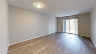 Located at Signal Pointe Circle in Sarasota, Florida, this single-story 2-bedroom, 1-bathroom residence offers a clean, modern aesthetic throughout. Light-toned luxury vinyl plank flooring runs continuously across all rooms, creating a cohesive and bright atmosphere. The open living room is bathed in natural light courtesy of a large sliding glass door that leads to an outdoor area, while a textured ceiling adds subtle character to the space.

The kitchen is thoughtfully updated, featuring crisp white shaker cabinetry with matte black hardware, a classic subway tile backsplash, light quartz countertops, and a full suite of black appliances including a refrigerator, range, and dishwasher. A window above the sink introduces additional natural light into the cooking space.

Both bedrooms are well-proportioned, each offering windows with vertical blinds, textured ceilings, and ample closet storage. The rooms are finished with the same neutral color palette that carries throughout the home.

The bathroom presents a stylish, updated design with white subway tile lining the tub-shower surround, matte black fixtures and accessories, a white vanity with a quartz-style countertop, and coordinating vinyl plank flooring. A connecting hallway ties all rooms together in a practical, efficient layout ideal for everyday living.
