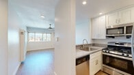 Located in North Hollywood, this one-bedroom, one-bathroom unit at 6235 Beck Ave offers a well-designed layout across a single floor. The open-concept kitchen is appointed with crisp white shaker cabinetry, gray quartz-style countertops, stainless steel appliances including a refrigerator, microwave, and dishwasher, and recessed lighting overhead. Light wood-style flooring flows through the kitchen and living areas, creating a clean, cohesive look throughout. The living room is bright and airy, benefiting from a wide window that frames views of the surrounding neighborhood and the distant hills, while a ceiling fan adds comfort year-round. The bedroom features plush carpeting, a ceiling fan, a mirrored sliding-door closet, and a window with natural light and neighborhood views. In total, the unit includes three closets, offering generous storage. The bathroom is finished in a clean, neutral palette with a full tub-shower combination and a white vanity. The overall ambiance is fresh and modern, with a light, neutral color scheme throughout that maximizes the sense of space and brightness.