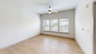 Located at 962 Mabry Hood Rd in Knoxville, Tennessee, this one-bedroom, one-bathroom unit offers a thoughtfully designed layout across a single floor. Light-toned hardwood-style flooring flows through the open-concept kitchen and living area, creating a clean and cohesive aesthetic. The kitchen is a standout feature, showcasing two-tone cabinetry with crisp white upper cabinets and slate-blue lower cabinets, complemented by white quartz countertops, a classic subway tile backsplash, and a full suite of stainless steel appliances including a refrigerator, range, microwave, and dishwasher. The living area benefits from large windows and a ceiling fan, allowing ample natural light and outdoor views of the surrounding community. The bedroom is carpeted for comfort, fitted with its own ceiling fan, and features two windows that provide additional natural light. It connects directly to a generously sized walk-in closet with built-in wire shelving, offering practical storage. The bathroom is finished in a clean, modern style with a tiled shower-tub combination, a dark-toned vanity with a white countertop, and coordinating hardwood-style flooring. Overall, the unit presents a bright, contemporary atmosphere with cohesive finishes throughout.