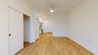 Located at 33 NE Kelly Ave in Gresham, Oregon, this thoughtfully designed studio unit offers a clean, modern aesthetic with an efficient, open-concept layout. Light hardwood flooring runs throughout the entire space, creating a warm and cohesive feel that enhances the bright, airy atmosphere.

The kitchen is a standout feature, equipped with full stainless steel appliances including a refrigerator, electric range, over-the-range microwave, and dishwasher. Crisp white cabinetry with matte black hardware lines the walls floor-to-ceiling, complemented by a classic white subway tile backsplash and a sleek undermount sink with a matte black faucet. Light countertops complete the contemporary look.

The open living area flows seamlessly from the kitchen, anchored by a ceiling fan with integrated lighting and recessed ceiling lights. A large window fills the living space with natural light and offers views of the surrounding Gresham neighborhood. A built-in closet provides convenient storage within the living area.

The bathroom features a full soaking tub and shower combination with a crisp white surround and matte black fixtures, maintaining the consistent modern design language found throughout the unit. Clean white walls and recessed lighting keep the space feeling fresh and functional.