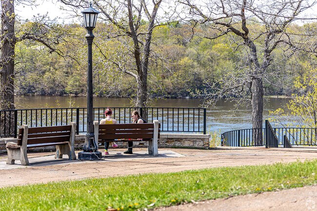People sit to take in river views.