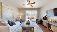 This thoughtfully designed single-floor residence offers a cohesive layout that balances comfort and functionality throughout. The living room serves as the heart of the home, featuring warm hardwood-style flooring, a ceiling fan, and large sliding glass doors that flood the space with natural light and open directly onto a private outdoor patio — ideal for relaxing or entertaining. Adjacent to the living area, a dedicated dining nook provides an intimate setting, highlighted by a pendant light overhead and hardwood-style flooring that continues the warm aesthetic. The galley kitchen is efficiently arranged with white cabinetry, stainless steel appliances including a refrigerator, range, and dishwasher, and durable countertops — all set atop easy-care hardwood-style flooring. The bedroom is a serene retreat with plush carpeting, a ceiling fan, a natural light-admitting window, and ample dresser space. Two bathrooms serve the residence, each featuring a tub-shower combination and clean, neutral finishes with hardwood-style flooring. A dedicated in-unit laundry closet with a full-size washer and dryer adds everyday convenience. Neutral tones and consistent finishes throughout lend the entire space a cohesive, welcoming ambiance.