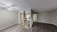Located at 110 Hanover Pl in Athens, GA, this single-floor unit offers a well-planned layout designed for comfortable everyday living. The main living area is bright and open, featuring durable wood-look vinyl plank flooring in a warm gray tone, neutral-painted walls, and a textured ceiling throughout. A standout feature is the set of French doors that fill the living space with natural light and provide direct access to a private outdoor patio area.

The kitchen is thoughtfully designed with gray shaker-style cabinetry, light countertops, a peninsula breakfast bar that opens to the living area, and black appliances including a refrigerator and range. Light-toned vinyl plank flooring carries through the kitchen, complementing the overall design palette.

The bedrooms are carpeted and offer a comfortable, quiet retreat, each finished with neutral gray walls and windows that allow natural light. One bedroom includes a dedicated closet with built-in shelving for added storage.

The bathroom area includes a vanity with granite-style countertops, gray cabinetry, and an adjacent walk-in closet, providing functional storage solutions. Throughout the unit, consistent finishes and a clean, modern aesthetic create a cohesive and inviting atmosphere.