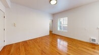 Located in the heart of Portland at SW Alder Street, this one-bedroom, one-bathroom unit offers a well-organized layout across a single floor. Warm hardwood flooring runs throughout the entire space, adding continuity and a polished feel to every room.

The combined kitchen and living area serves as the central hub of the unit. The living space is bright and open, benefiting from two windows fitted with blinds that allow natural light to fill the room. The kitchen is efficiently designed with white shaker-style cabinetry, gray laminate countertops, a stainless steel sink with a brushed nickel faucet, and a white electric range — offering all the essentials within a compact footprint.

The bedroom is a comfortable, well-proportioned retreat with its own window that brings in natural light, clean white walls, and the same hardwood flooring found throughout. A dedicated closet off the bedroom features built-in shelving and a hanging rod, providing practical everyday storage.

The bathroom is finished with classic white subway tile in the tub-shower surround, complemented by brushed nickel fixtures, delivering a clean and timeless aesthetic.

Overall, this unit presents a straightforward, functional design with consistent finishes and a bright, neutral palette well-suited for urban living in downtown Portland.