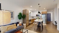 Located in Oakdale, MN, this thoughtfully designed one-bedroom, one-bathroom residence offers a smart and functional layout across a single floor. The open-concept kitchen and living area serves as the heart of the home, featuring two-tone cabinetry with warm wood and crisp white finishes, a subway tile backsplash, stainless steel appliances, and a central island with bar seating illuminated by sleek pendant lighting. The living room is bright and welcoming, with large windows and a sliding glass door that opens to a private balcony, filling the space with natural light. The bedroom is a calm retreat with a window overlooking the exterior and plush carpeted flooring. A dedicated office provides a quiet, carpeted workspace separate from the main living area. The full bathroom features wood-toned cabinetry, a white quartz countertop, a tub-shower combo, and built-in open shelving for additional storage. A clean, well-lit hallway connects all rooms, with wood-look flooring flowing throughout the main areas. The overall design balances modern aesthetics with practical comfort, making efficient use of every square foot.