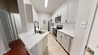 This expansive townhouse in Coppell, TX offers 1510 square feet of living space across two floors. The home boasts five bedrooms, including a generous 260 square foot primary suite, and two full bathrooms. The ground floor spans 410 square feet, while the upper level provides 1090 square feet of space.

The interior showcases a blend of modern finishes and practical design. The kitchen features white cabinetry, stainless steel appliances, and a hexagonal tile backsplash, creating a contemporary aesthetic. Hardwood floors grace several rooms, adding warmth and elegance to the living areas. Large windows in the bedrooms and living spaces allow for ample natural light, enhancing the home's airy ambiance.

The bathrooms are equipped with modern fixtures, including a shower/tub combination with neutral tiling. The property also includes a laundry area with a top-loading washer, demonstrating thoughtful consideration for daily conveniences. An attached garage provides secure parking and additional storage space.

The home's layout includes a hallway, multiple closets, and two staircases, ensuring easy navigation between floors and ample storage options. With its combination of space, modern amenities, and prime location, this townhouse presents an attractive option for families or those seeking a roomy, contemporary living space.