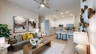 Located at 7311 Baymeadows Way in Jacksonville, FL, this 2-bedroom, 2-bathroom residence offers a well-designed single-floor layout that balances comfort and modern style. The open-concept living, dining, and kitchen area forms the heart of the home, highlighted by wood-look flooring, recessed lighting, and a ceiling fan that enhances airflow throughout. Large windows and a glass door flood the living room with natural light while providing direct access to a private balcony overlooking a resort-style pool and lush landscaping with palm trees. The kitchen is thoughtfully appointed with white upper cabinetry, light gray lower cabinets, granite countertops, a classic subway tile backsplash, stainless steel appliances, and a breakfast bar with seating. The primary bedroom is a generously sized retreat featuring tall ceilings and ample closet space. Both bathrooms are finished with granite vanity countertops and walk-in glass shower enclosures complemented by wood floating shelves. An accent wall in sage green adds a distinctive design touch to the living area. Additional conveniences include in-unit laundry and multiple closets throughout. The overall ambiance is clean, contemporary, and inviting.