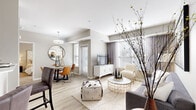 Located at 2720 S Highland Ave in Lombard, IL, this well-appointed 2-bedroom, 2-bathroom residence offers a thoughtfully designed single-floor layout that maximizes comfort and functionality. The open-concept living and dining area is bathed in natural light from large windows dressed with elegant drapes and blinds, creating a bright and welcoming atmosphere. Light wood-style flooring flows throughout the main living spaces, complementing the neutral, contemporary color palette.

The kitchen is equipped with rich dark cabinetry, stainless steel appliances, a mosaic tile backsplash, and crisp white countertops — combining style with practicality. The dining area features a charming nook with a window door, adding an airy feel to mealtimes.

Both bedrooms are carpeted for comfort and feature ceiling fans and generous natural light. The primary bedroom offers a well-proportioned retreat, while the second bedroom is equally inviting. Each bathroom is finished with dark wood vanities, white quartz countertops, large mirrors, and wood-look tile flooring. One bathroom includes a soaking tub with a tiled surround, while the other features a walk-in shower. A hallway and closet provide additional storage, rounding out this modern and efficiently designed residence.