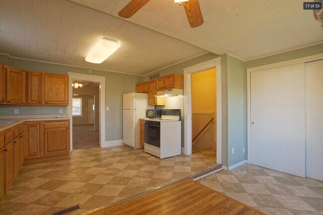 Kitchen with access to basement - 702 W Winona Ave