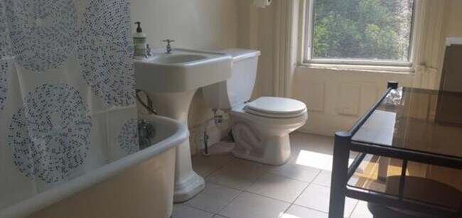 Original cast-iron sink and clawfoot tub with shower head - 198 Hancock St