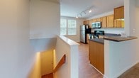 Located at 3900 Squire Hill Ct in North Chesterfield, Virginia, this single-floor residence offers a practical and comfortable layout throughout. The spacious living area is finished with plush wall-to-wall carpeting and features large sliding glass doors fitted with vertical blinds, allowing generous natural light and providing direct access to the outdoors with views of surrounding greenery.

The kitchen is thoughtfully designed with warm honey-toned cabinetry, dark speckled countertops, and hardwood-style flooring. It is equipped with stainless steel appliances including a refrigerator, electric range, and an over-the-range microwave, along with ample upper and lower cabinet storage. Track lighting overhead ensures the space is well-lit.

The bedrooms are carpeted and finished with clean white walls, offering a bright and neutral palette. Closet access is provided within the bedroom areas. The bathrooms include a full bath with a soaking tub and shower combination featuring chrome fixtures, as well as a second bathroom with warm wood-toned cabinetry, a single-sink vanity with a white countertop, wood-style flooring, and convenient in-unit laundry access. The overall ambiance is clean, functional, and move-in ready.