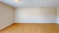 Located at 500 Big Forrest Ct in Newport News, Virginia, this single-floor, 2-bedroom, 1-bathroom home offers a functional and comfortable layout. The open-concept living area is finished with light hardwood-style flooring, neutral beige walls, and windows that invite natural light, creating a bright and welcoming atmosphere.

The U-shaped kitchen is well-appointed with warm medium-tone wood cabinetry providing ample storage, light-colored countertops, and white appliances including a range, refrigerator, and dishwasher. A pass-through opening connects the kitchen to the living area, enhancing the sense of openness throughout the main space.

Both bedrooms feature soft carpeting and neutral walls. The primary bedroom includes a double-door closet, while the second bedroom benefits from a window with outdoor views. Each room provides a calm, versatile environment.

The bathroom is equipped with a walk-in shower stall featuring a handheld showerhead and grab bars, complemented by hardwood-style flooring. The single-floor layout ensures easy accessibility throughout the entire home, making it a practical and efficient living space.