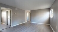 Located at 4111 N Poplar Ave in Tampa, Florida, this single-story home has been thoughtfully updated with modern finishes throughout. The interior showcases consistent luxury vinyl plank flooring across all living areas and bedrooms, complemented by neutral gray walls and crisp white baseboards that create a clean, contemporary aesthetic.

The open living area welcomes you with ample natural light filtering through window blinds, offering a bright and airy atmosphere. The updated kitchen is a functional highlight, featuring white shaker-style cabinetry, light quartz countertops, a stainless steel sink with a brushed nickel pull-down faucet, and a full suite of stainless steel appliances including a dishwasher, electric range, and over-the-range microwave.

The bedrooms are generously sized, each benefiting from natural light through sizable windows. One bedroom includes a sliding-door closet, providing practical built-in storage. The bathroom is well-appointed with a white vanity, light quartz countertop, tile-surround soaking tub and shower combination, and a window that brings in natural light. Clean finishes and neutral tones are carried throughout, lending the space a cohesive, move-in-ready feel ideal for comfortable everyday living.
