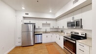 Located at 1932 NE 179th St in Ridgefield, WA, this single-floor, 4-bedroom, 2-bathroom home offers a thoughtfully designed layout that maximizes functionality. The bright, open living room features warm wood-style flooring, large windows that invite natural light, and a wall-mounted mini-split system for efficient climate control.

The kitchen is a standout feature, appointed with white shaker cabinetry extending to the ceiling, light quartz countertops, and a full suite of stainless steel appliances including a refrigerator, electric range, microwave, and dishwasher. The clean, modern aesthetic carries throughout the home.

Both bathrooms are finished with white vanity cabinetry, black hardware accents, quartz countertops, and well-lit mirrors, creating a crisp, contemporary feel. A dedicated laundry room houses a stacked GE front-load washer and dryer alongside built-in shelving for added storage convenience.

The four bedrooms vary in finish, with some featuring wood-style flooring and others offering plush carpet. Each room includes a window with blinds, providing natural light and privacy. A central hallway connects all rooms efficiently, and a dedicated closet adds further storage capacity. The home presents a clean, move-in-ready environment with a consistently modern design throughout.