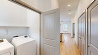 Located in Fort Worth, Texas, this two-story home offers a well-designed layout across two floors, with the majority of living space on the main level. The open-concept kitchen and living area serves as the heart of the home, featuring light hardwood-style flooring, high ceilings with recessed lighting, and abundant natural light. The kitchen is outfitted with crisp white cabinetry, granite countertops, a peninsula with pendant lighting, and a full suite of stainless steel appliances, including a refrigerator, range, microwave, and dishwasher. The bathrooms continue the refined aesthetic with granite vanity tops, marble-style tile surrounds, and wood-tone cabinetry. Bedrooms are thoughtfully appointed — some feature plush carpeting, ceiling fans, and window blinds, while others showcase the same hardwood-style flooring seen throughout the main living areas. The primary bedroom includes an en-suite bathroom and an organized walk-in closet. Two additional closets provide ample storage throughout the home. A staircase connects both floors, and a hallway adds to the functional flow of the layout. Outside, a fenced backyard with green lawn space offers a private outdoor retreat, as seen in the 3D overview of the property.