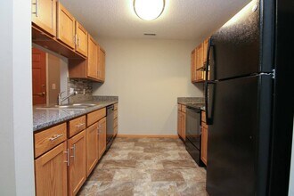 Updated kitchen with sleek black appliances and spacious countertops adorn our renovated apartments. - Northbrook Apartments